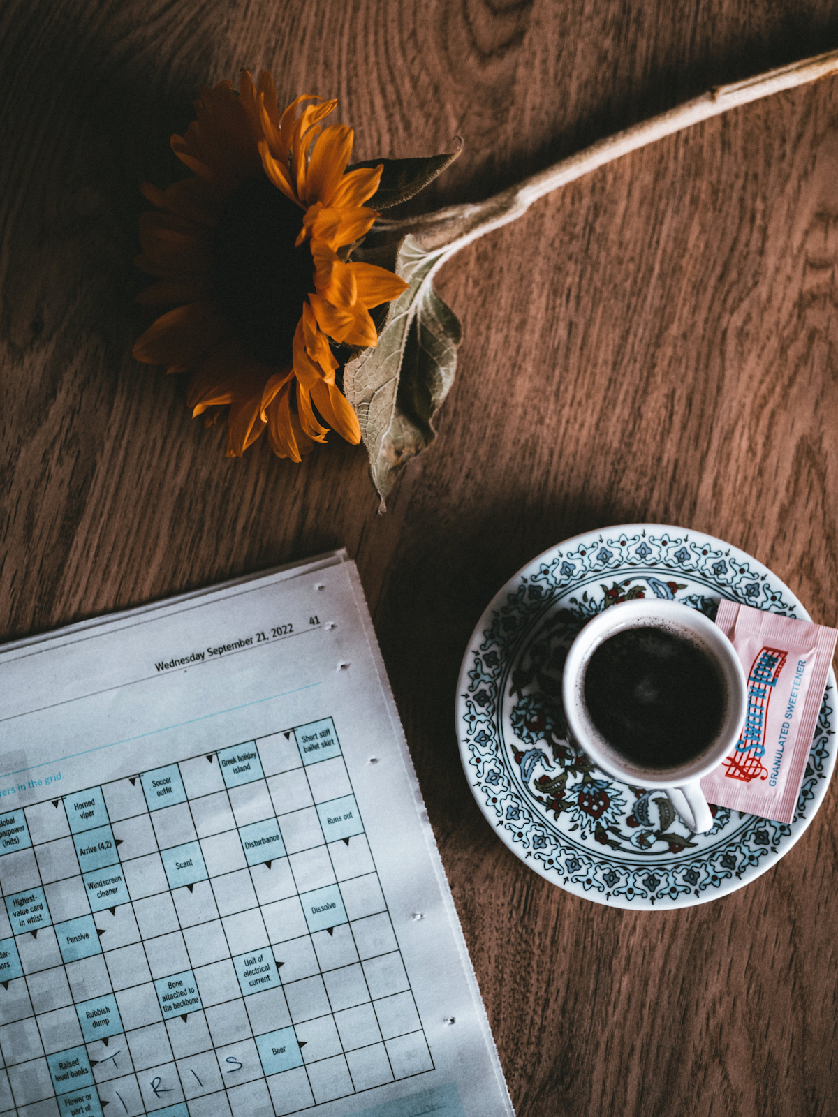 Crossword puzzle with coffee cup and sunflower