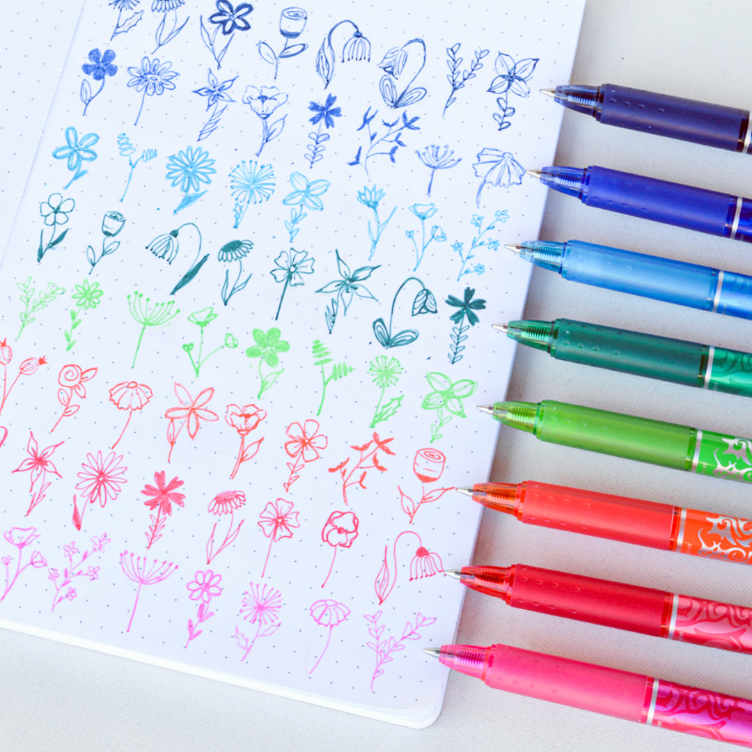 Row of colourful PILOT FriXion pens drawing flowers, choosing ink colours for how to write a thank you note.
