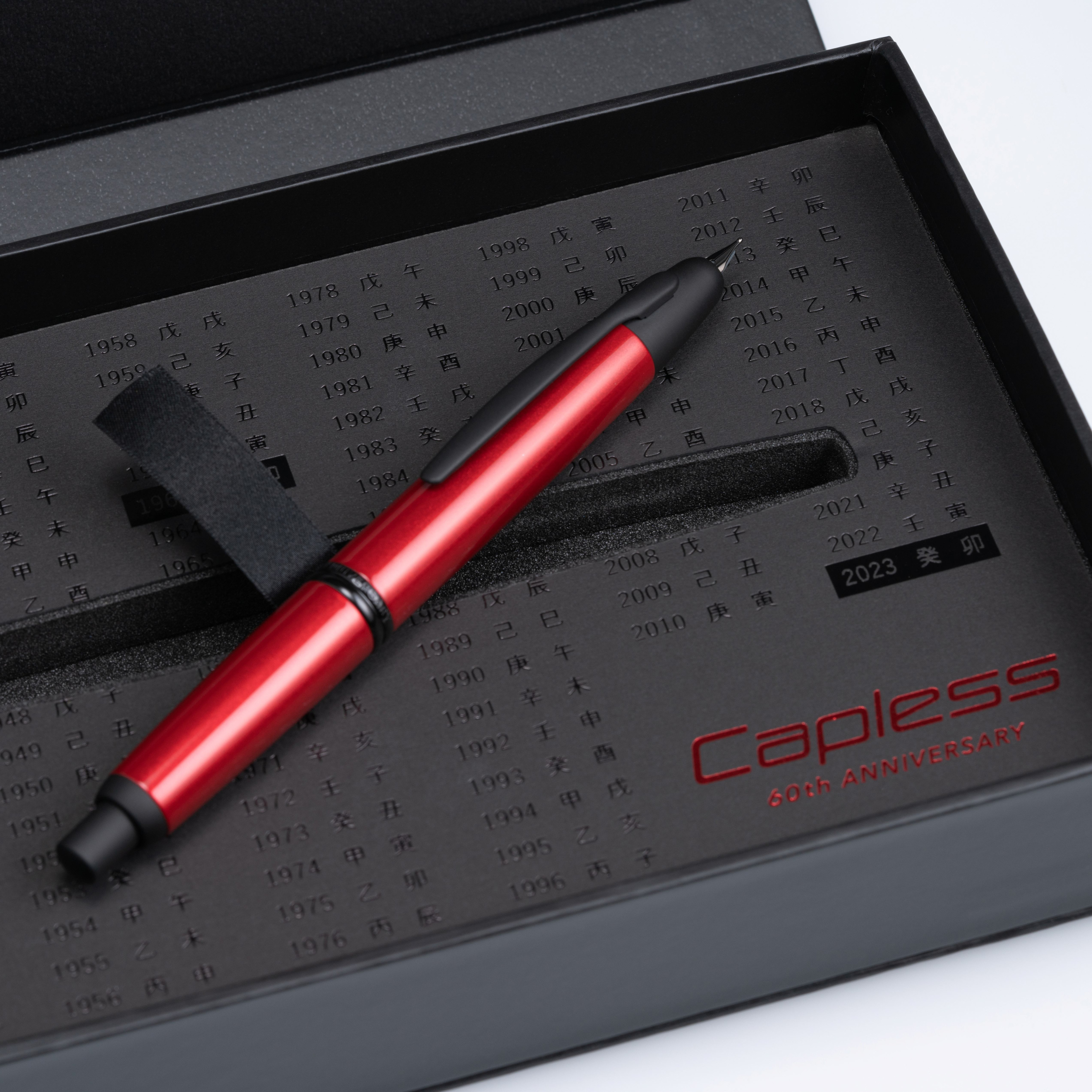 Pilot Capless 60th Anniversary Limited Edition fountain pen in red, displayed inside commemorative presentation box