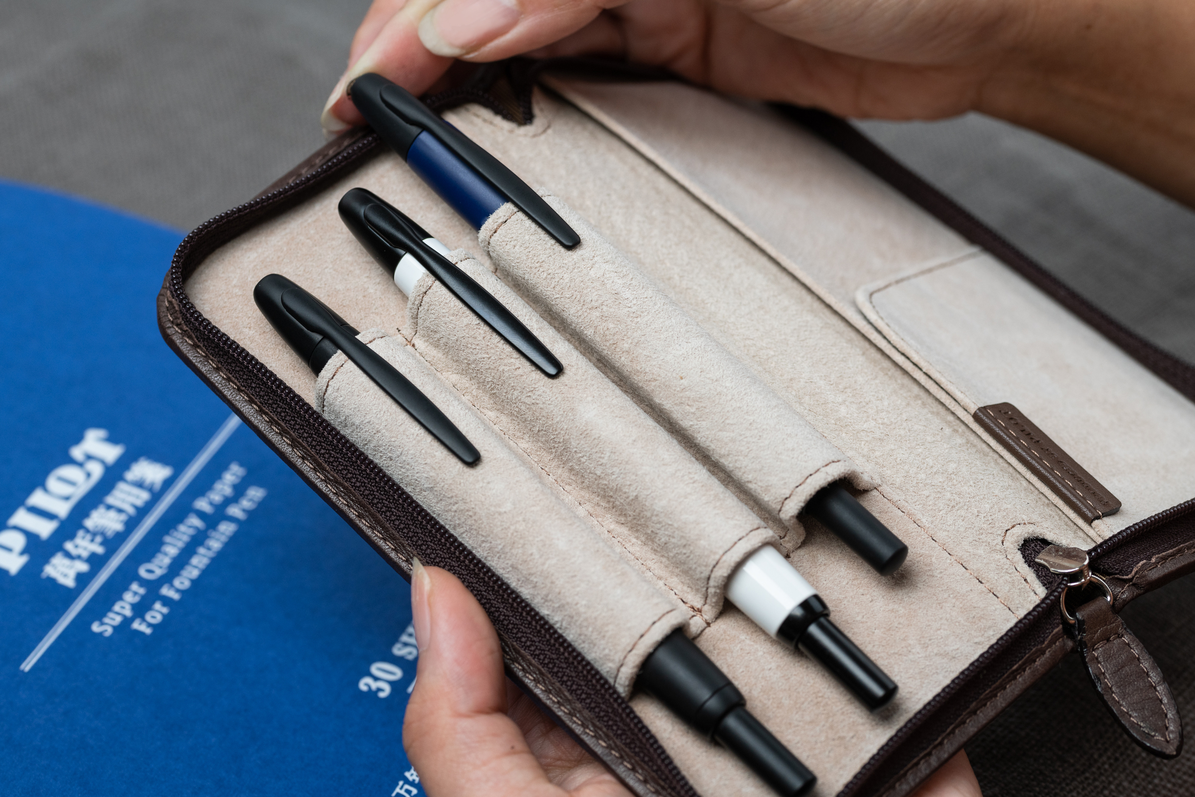Pilot Capless fountain pens stored in a leather pen case with multiple compartments