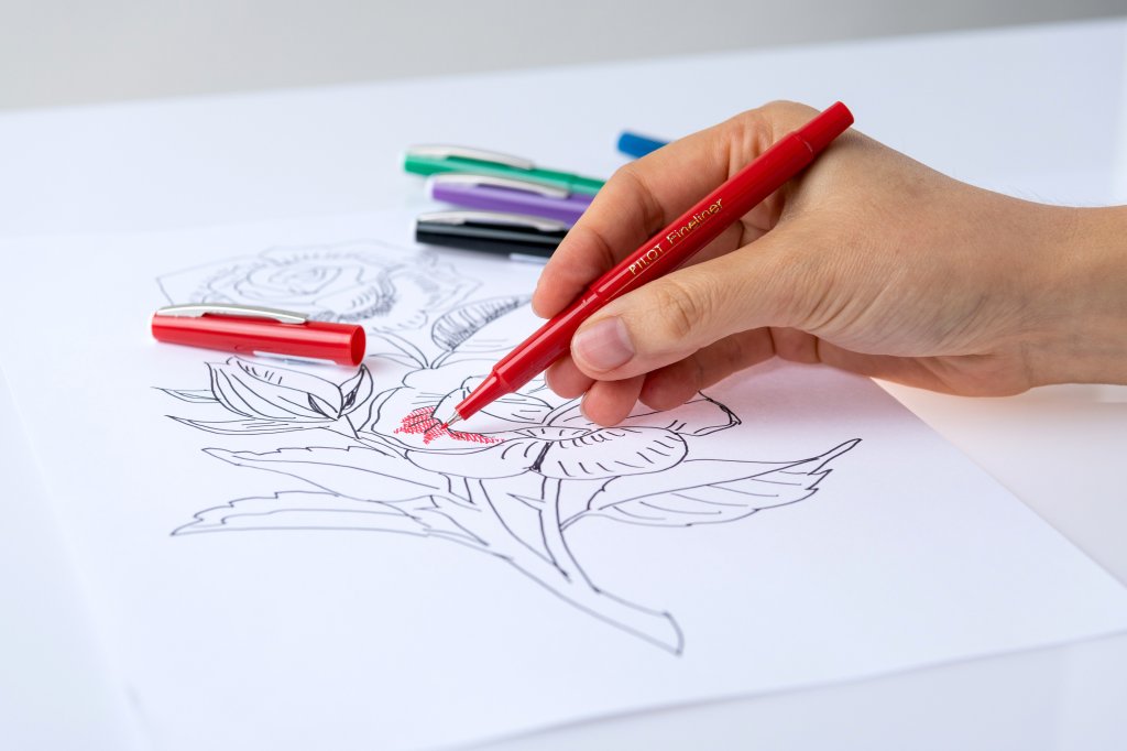 PILOT Pen Fineliner in red being used for drawing a flower.