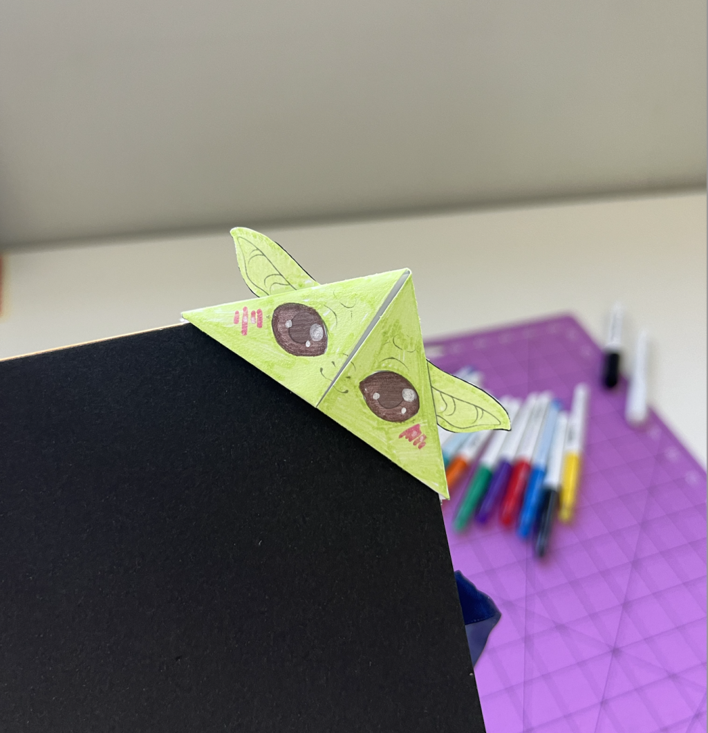 Grogu or Baby Yoda Green Bookmark with FriXion Color Erasable markers and Pintor Paint Markers in the background.