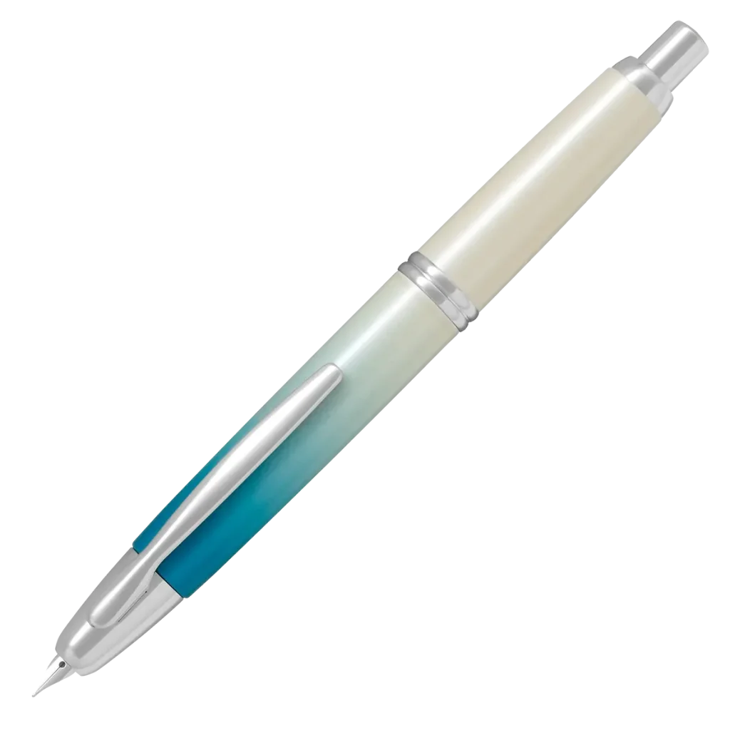 A PILOT Capless retractable fountain pen, featuring a limited edition barrel design called Seashore, that transitions from deep sea turquoise to a shimmering white, evoking pure sand on a coastline.